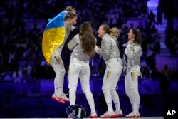 Kharlan (left) and her teammates celebrate their gold medal at the 2024 Paris Olympics on August 3.