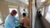 Пациент получает дозу вакцины "Спутник V в вагоне медицинского поезда на железнодорожной станции в городе Тулун Иркутской области