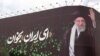 This picture shows a billboard bearing the portrait of Iranian supreme leader Ayatollah Ali Khamenei and a quote reads in Persian 'Sing Oh Iran' at the Enqelab Square in Tehran on July 9.