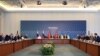 Members of Ukrainian (R), Russian (L) and Turkish (C) delegations attend peace talks at the Ciragan Palace in Istanbul, June 2, 2025.