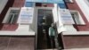 A man walks out of a building near posters informing of the upcoming referendum in Almaty, Kazakhstan, on June 1. 