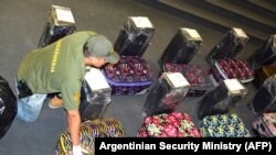 Аргентинский полицейский у чемоданов с кокаином, которые были найдены в посольстве России в Буэнос-Айресе, 14 декабря 2016 года
