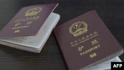 A handout video grab from footage published on the social media pages of Ukrainian President Volodymyr Zelenskyy shows alleged Chinese passports of two men captured by Ukraine's military. 