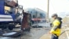 A firefighter by a passenger train hit by a Russian drone strike in Shostka, October 4, 2025, in a photo provided by Ukrainian police 